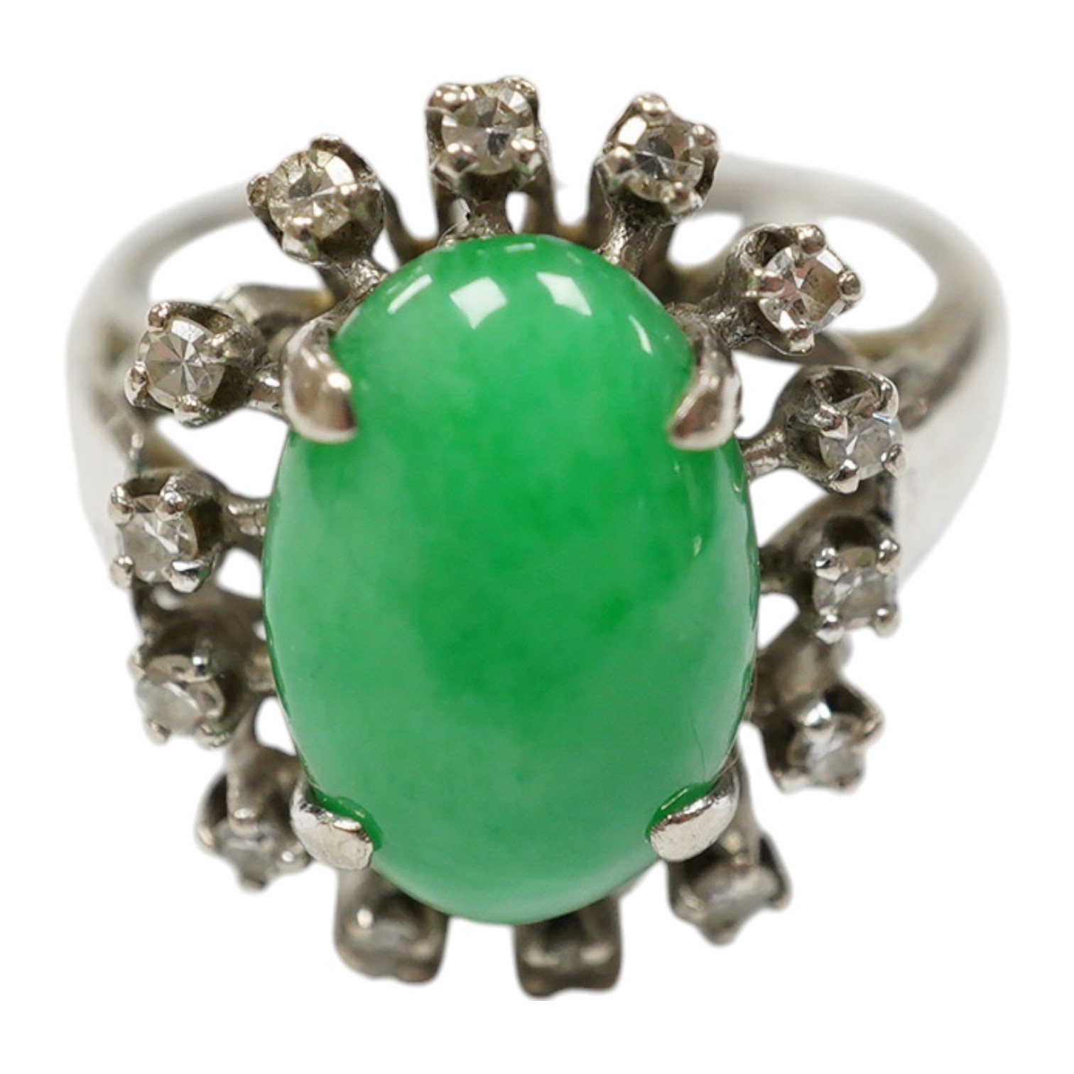 A white metal, jade and diamond set oval cluster ring, size N, gross weight 5.4 grams. Condition - fair to good